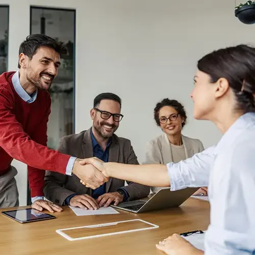 A group of 4 professionals shaking hands